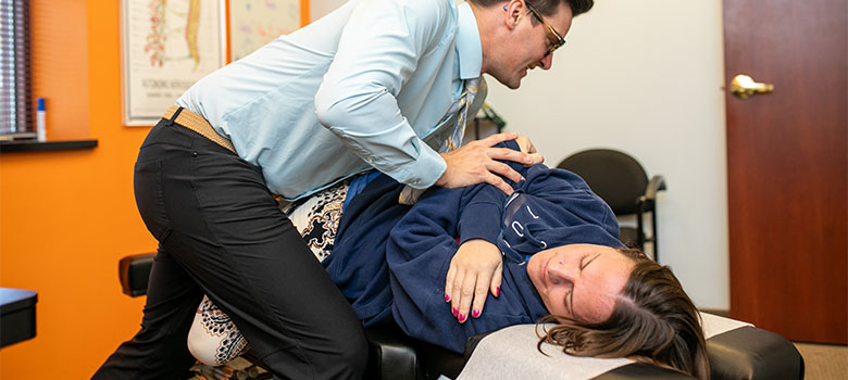 A pregnant women wearing a pink shirt.