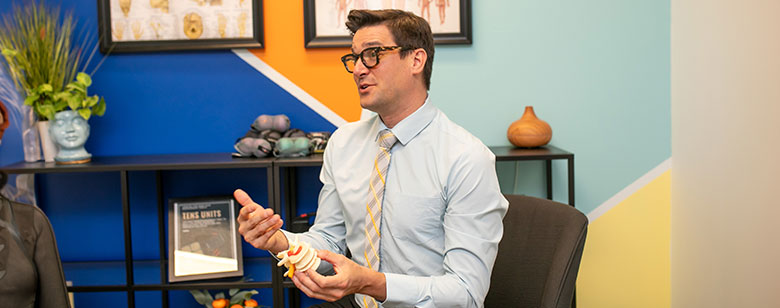 Dr. Bomberg adjusting a women's neck.